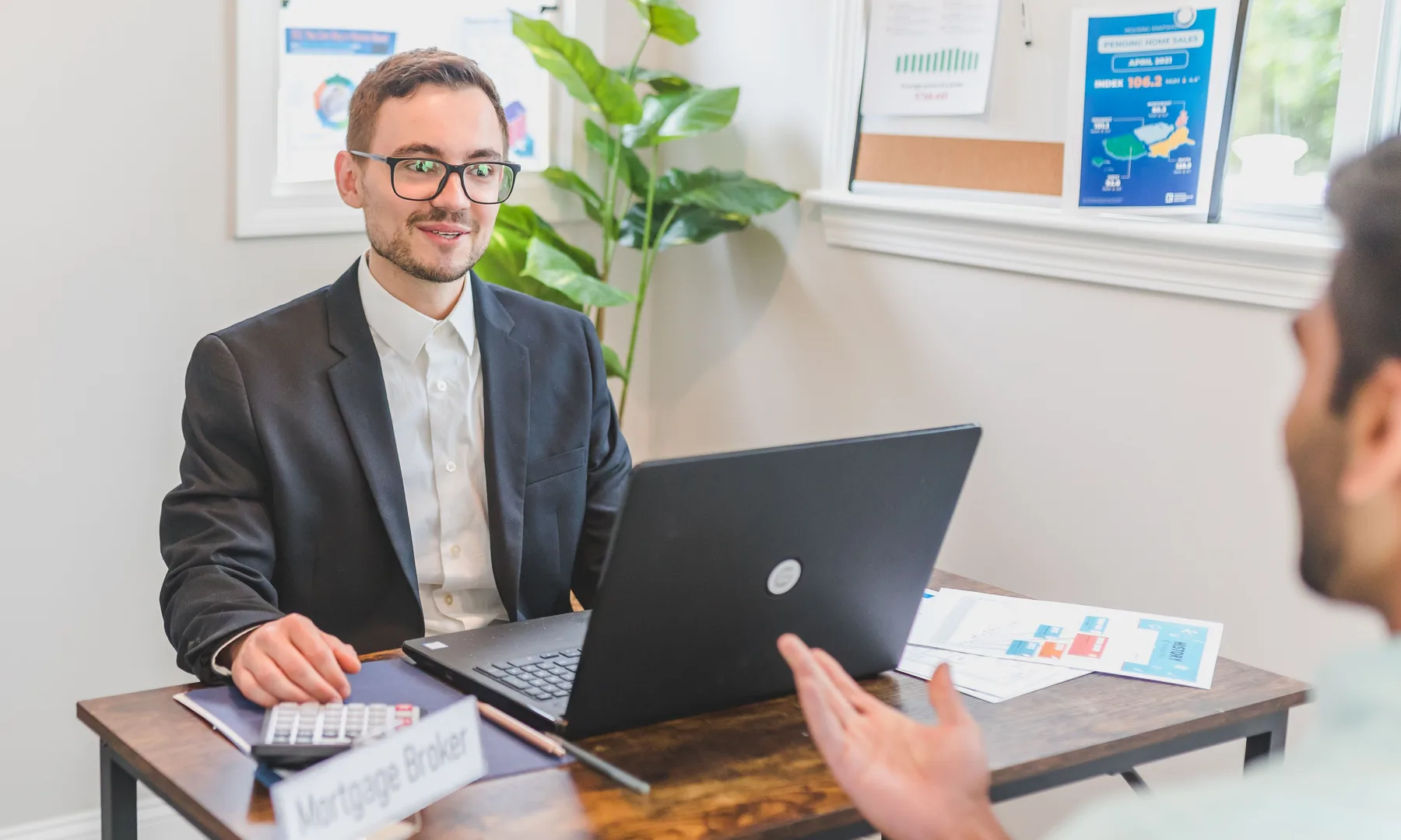 Mortgage adviser explaining finance documents to a property buyer