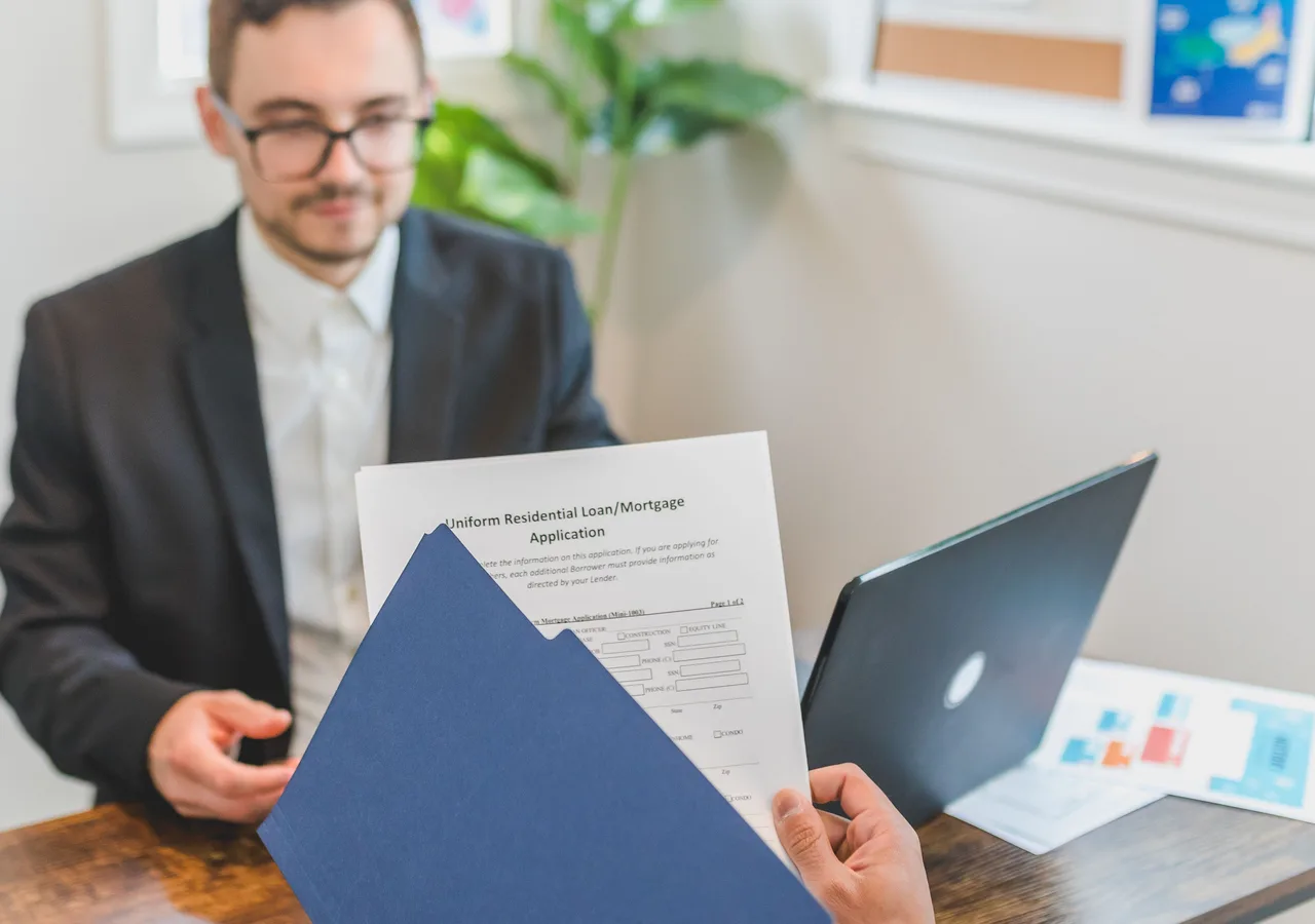 Mortgage rate documents, calculator and property keys on a desk